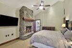 Master Bedroom Stone Fireplace and Large Smart TV
